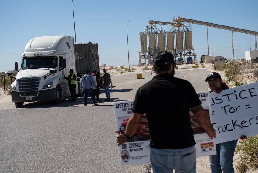 Members of the Truckers Movement for Justice flag down semi-truck drivers to share educational and promotional material as they protests outside of the Capital Sand mine Monday, July 1, 2024, in Monahans. The group, led by Billy Randel, protested across the Permian Basin Monday, calling for better wages and working conditions within the trucking industry.